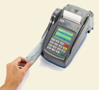 FD200 terminal with check being slid through for processing